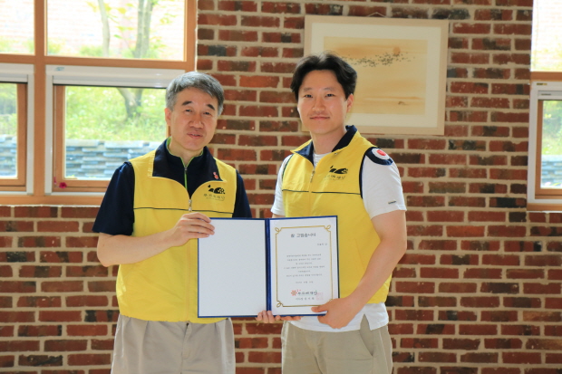 백경학 푸르메재단 상임이사에게서 감사장을 전달받은 우효석 치위생사(오른쪽)