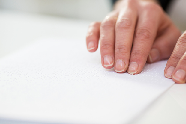 점자를 읽고 있는 시각장애인