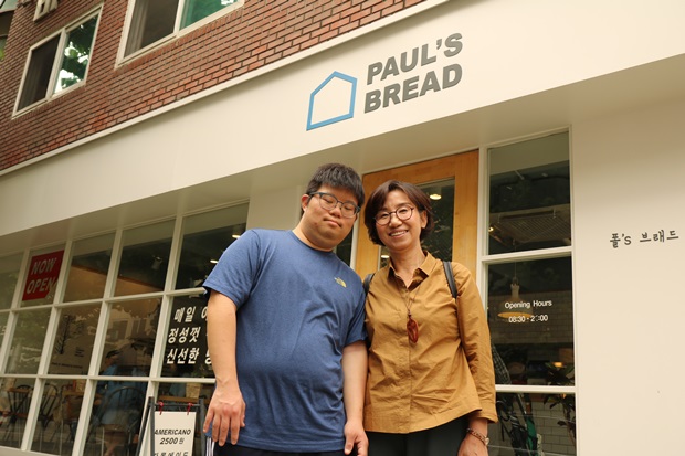 보호작업장 건물 앞에 선 다정한 모자.